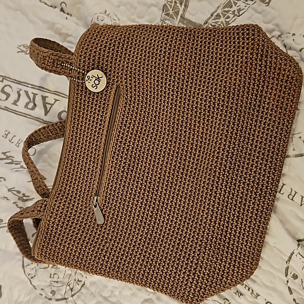 The Sak crochet purse.  New w/o tags.  Tan. Beautiful bag. Smoke free home.